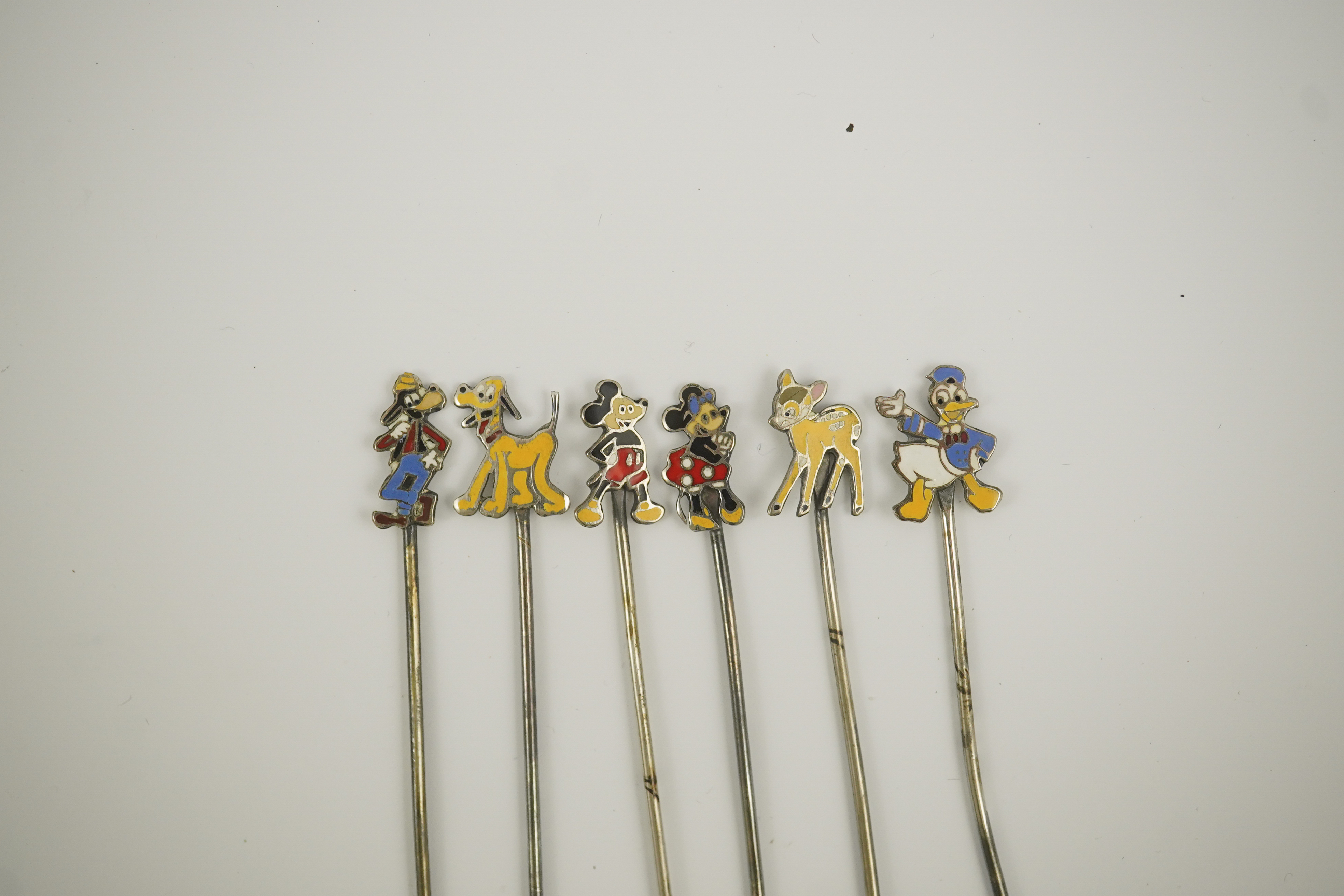 A cased set of six enamelled sterling Disney Character cocktail sticks